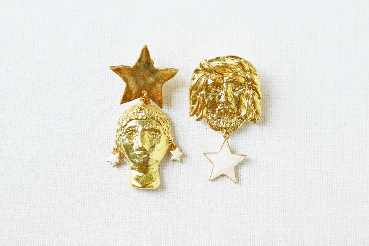 Boucles d’oreilles asymétriques en laiton doré représentant Amfitrite et Poséidon avec des étoiles.